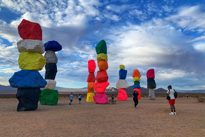 Experience the stunning Seven Magic Mountains where towering colorful sculptures create a unique backdrop for unforgettable photos and moments during your Hoover Dam Walk-On-Top Tour.